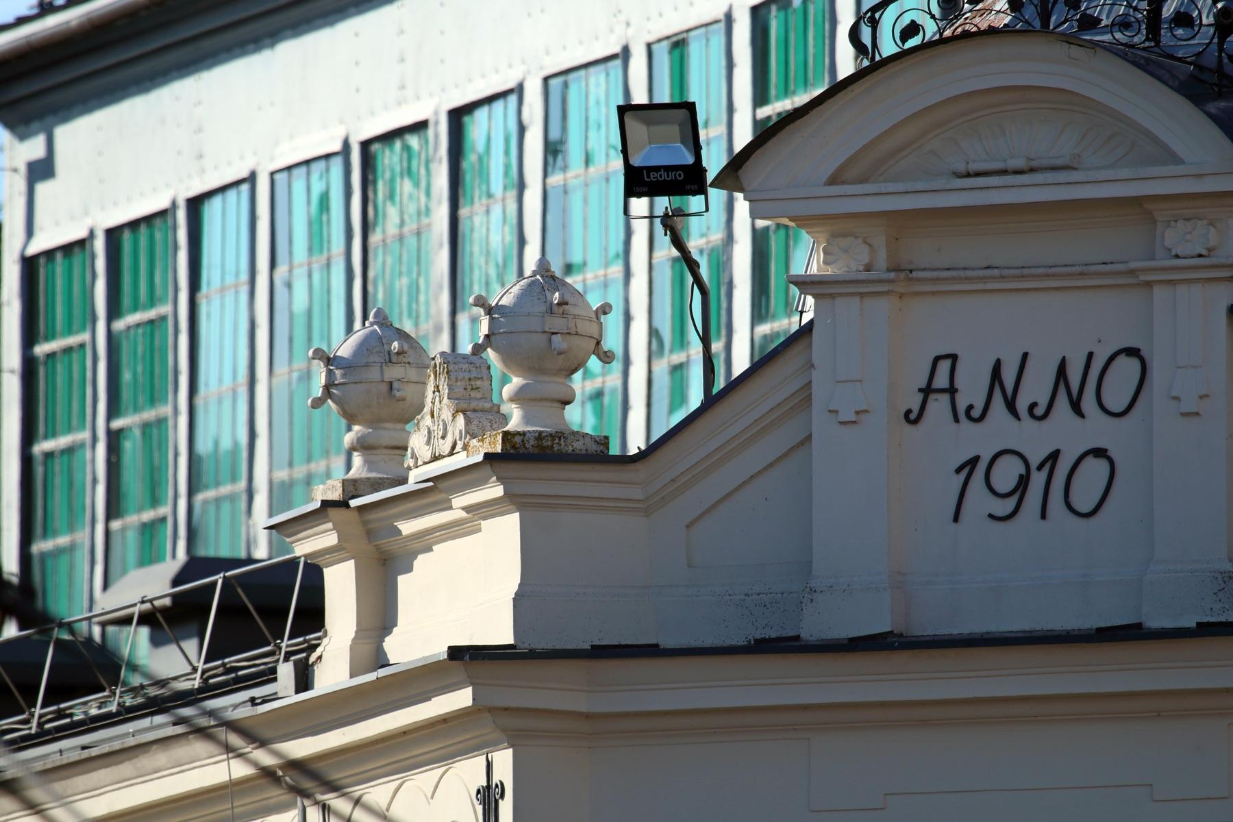Heritage façade with ANNO 1910 pediment and decorative urn finials